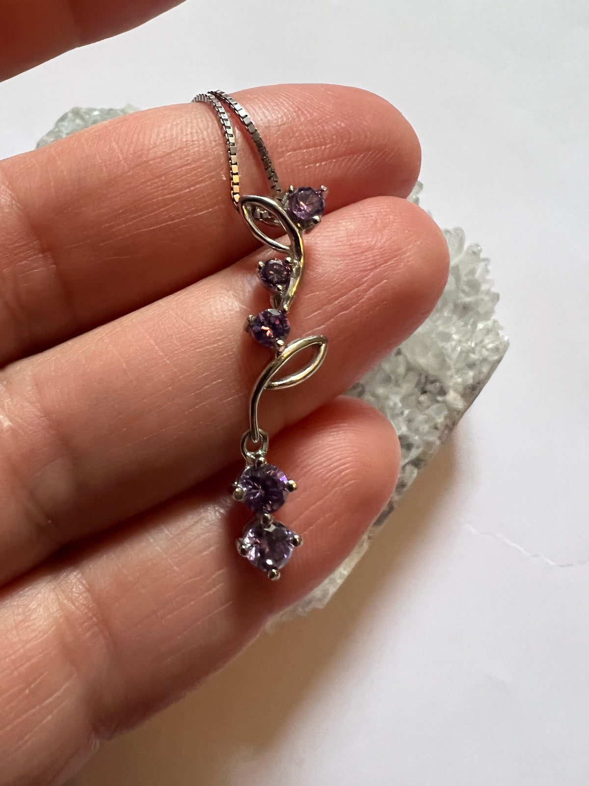Faceted Amethyst Flower Vein pendant on a sterling silver necklace