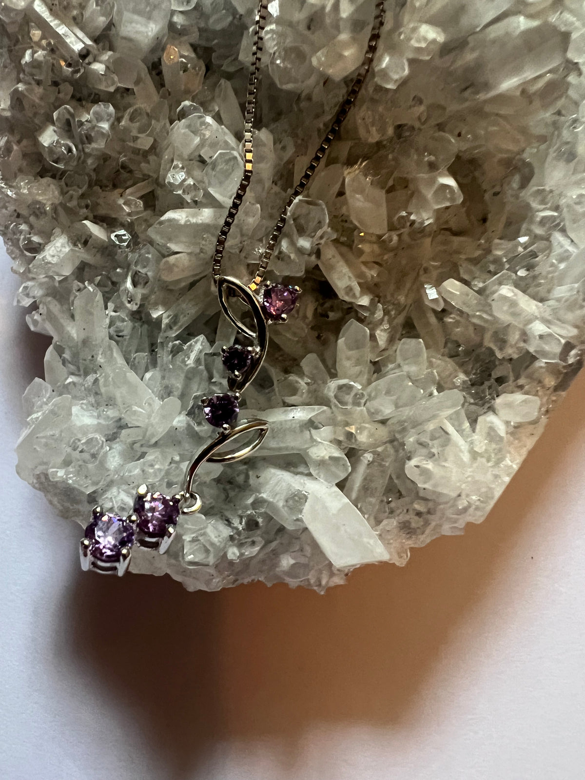 Faceted Amethyst Flower Vein pendant on a sterling silver necklace